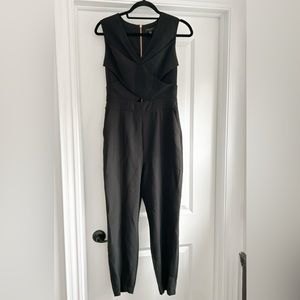Black Ted Baker jumpsuit with criss cross detail in front.